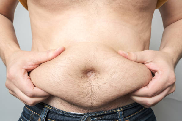 istock Man checking his weight isolated over gray background 1207040559