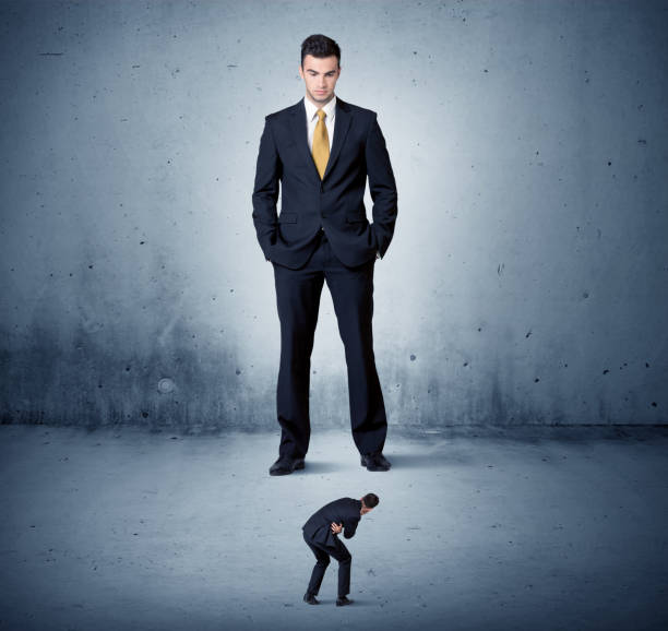 istock Angry huge business man looking at small guy 1207040816