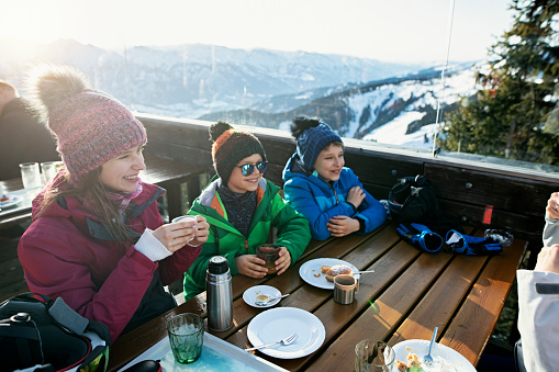 Little skiers eating lunch in alpine ski bar
