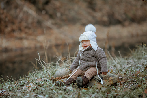 Portrait of cute boy in warm clothes looking at camera