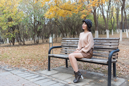 Beauty Girl Sitting on a bench