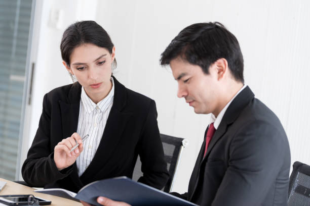 istock A manager and secretary working together in the office. 1207046936