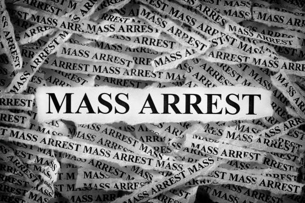 istock Strips of newspaper with the word Mass Arrest typed on them 1207047245