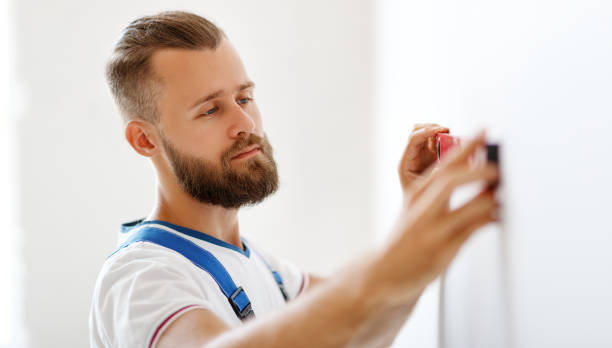 istock male worker makes repairs with level aligns walls 1207047894