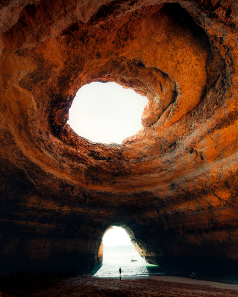 istock Huge orange cave by the ocean 1207049495
