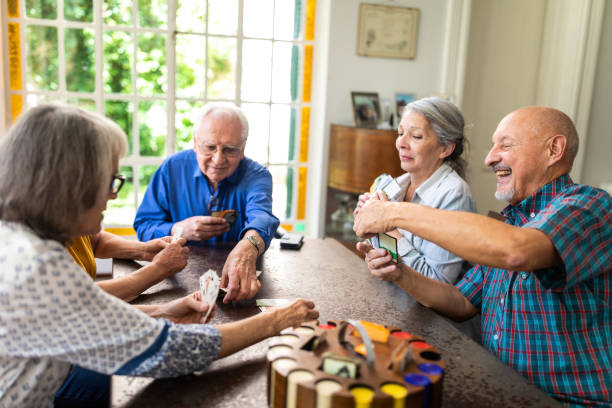 istock Senior friends playing poker at home 1207050278