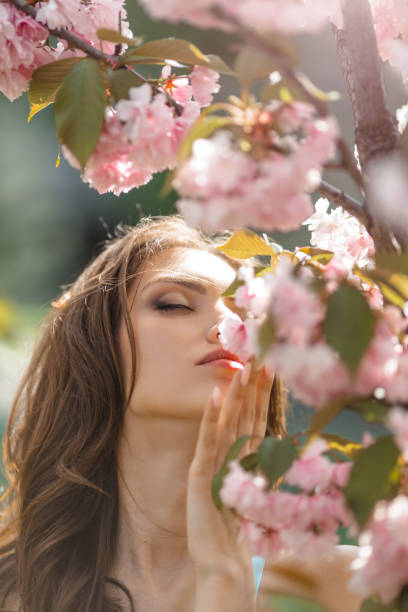istock Woman at Blossoming Sakura Tree on Nature 1207050378