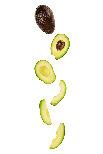 Falling avocado isolated on white background with clipping path as package design element and advertising. Flying foods. Floating, hanging fruits in the air. Copy space. Vertical orientation.