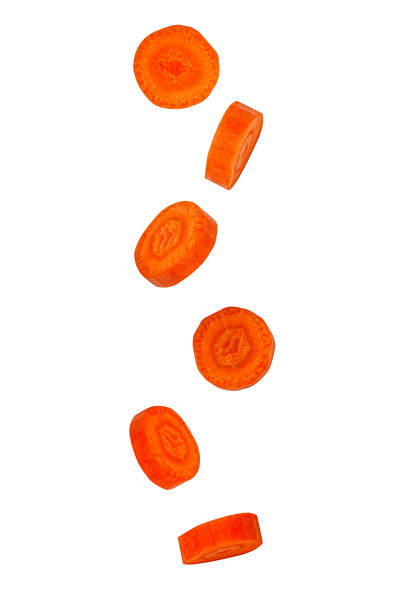 istock Falling pieces of carrot isolated on white background, close-up. 1207050468
