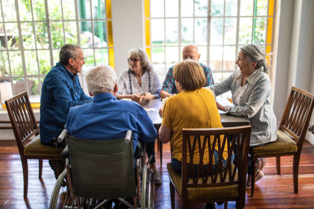 istock Senior friends playing cards at home 1207050540