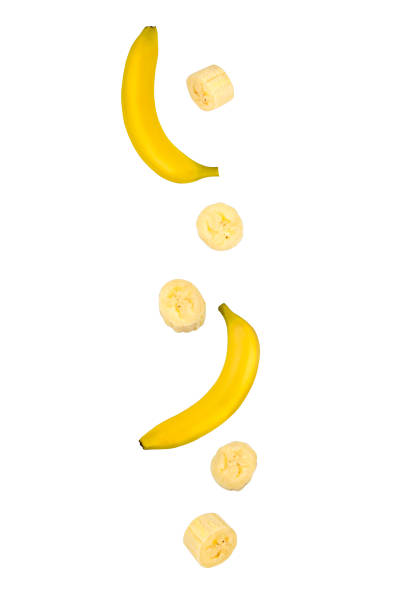 istock Falling whole and banana pieces isolated on white background, close-up. 1207050551