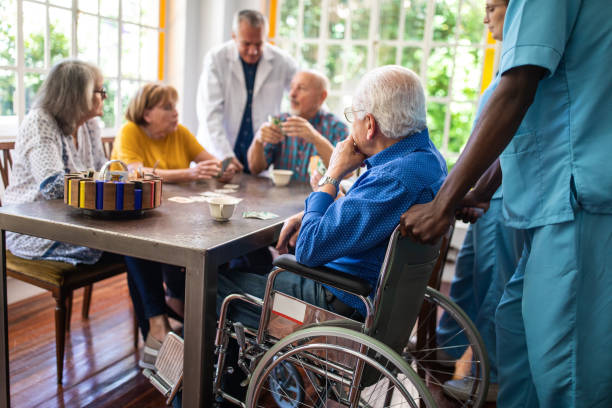 istock Seniors having fun playing card games at retirement home 1207050655