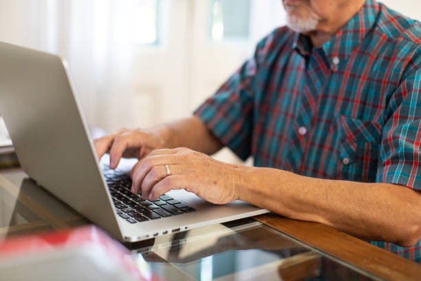 istock Senior man using laptop in nursing home 1207051964