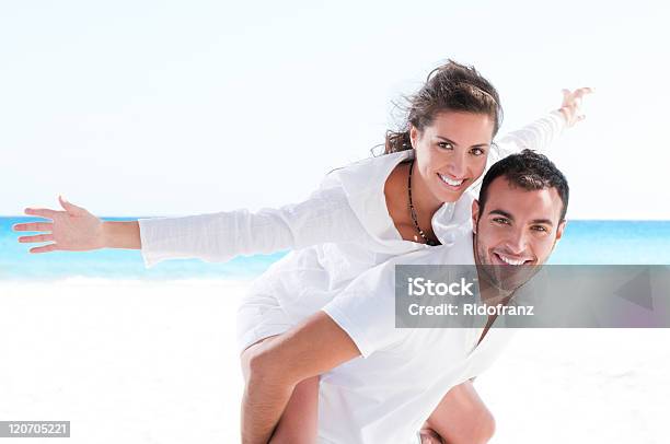 Young Couple Together At The Beach Stock Photo - Download Image Now - Couple - Relationship, Caribbean Sea, Two People