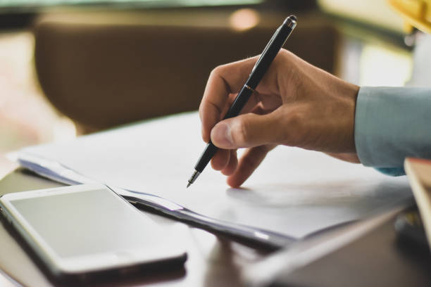 istock Close up hand sign contract on document business agreement success concept 1207052238