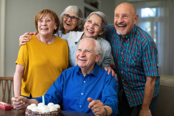 istock Happy friends celebrating birthday at home 1207052257