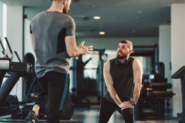 istock Two Handsome young man have have a conversation at the gym 1207052388