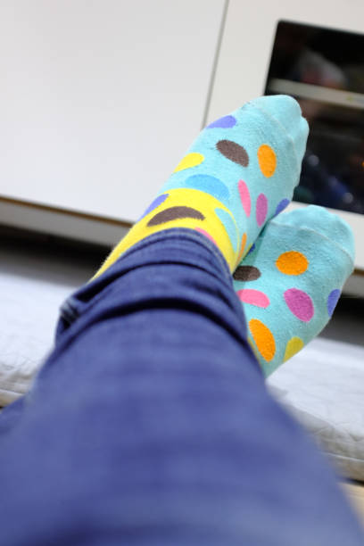 istock Colorful sotted socks and blue jeans lying on the floor 1207054059