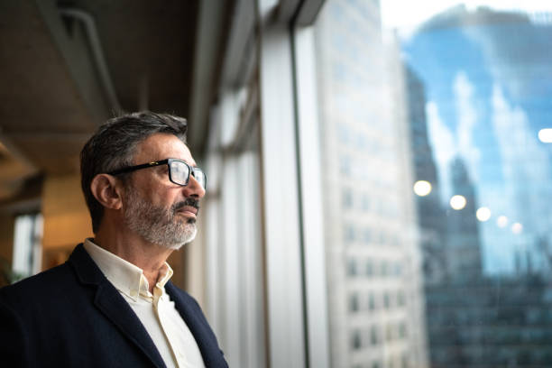 istock Mature businessman looking out of window 1207054663