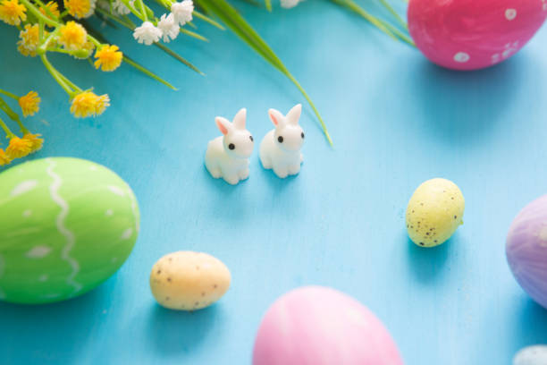 istock Easter eggs decoration with flowers on blue wooden table 1207056186