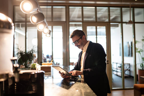 istock Mature businessman using digital tablet at modern office 1207056210