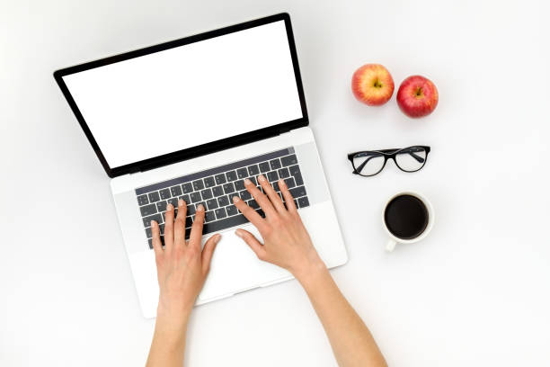 istock Top view of beautiful woman 's hands using laptop placed on white desktop. Flat lay 1207056854