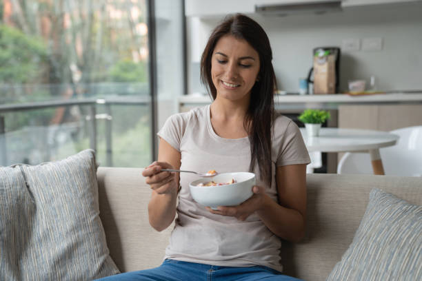 istock Woman at home eating a parfait for breakfast 1207059257