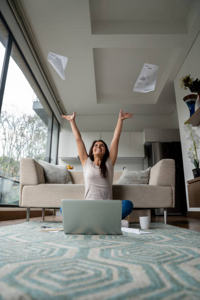 istock Woman working from home and celebrating an achievement 1207059408