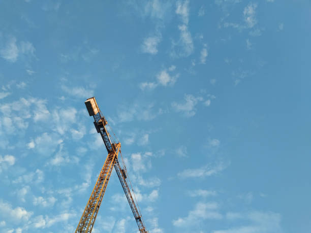 Crane on a background of blue sky. Bottom view