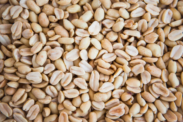 istock Batch of peanuts on the wooden background 1207060279