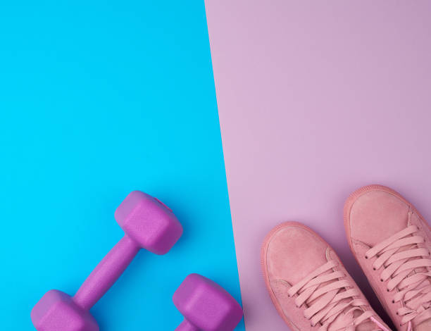 istock pair of pink leather sneakers, plastic dumbbells 1207060638