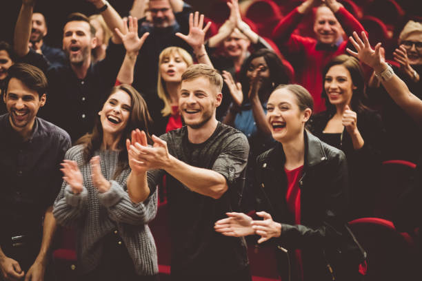 Happy audience applauding in the theater Group of excited people clapping hands in the theater. comedian stock pictures, royalty-free photos & images
