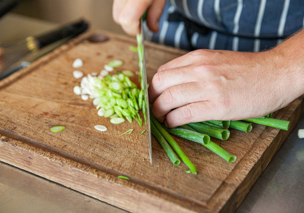 Chef chopping spring onions stock photo