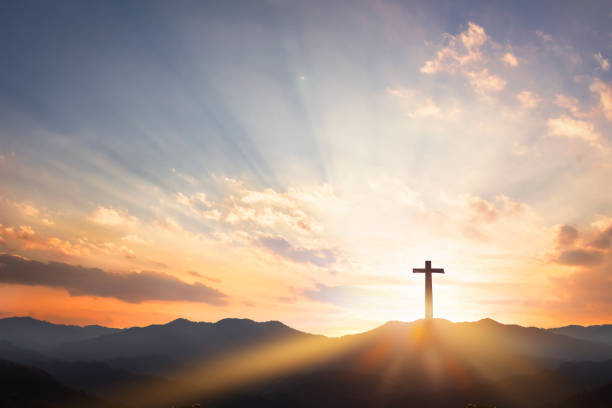 istock Good Friday concept: cross with sunset in the sky background 1207065797