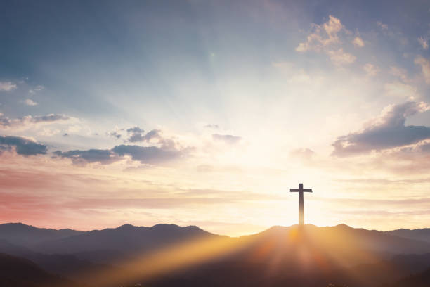 istock Good Friday concept: cross with sunset in the sky background 1207065798