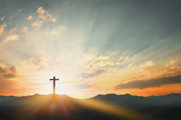 Good Friday concept: cross with sunset in the sky background stock photo