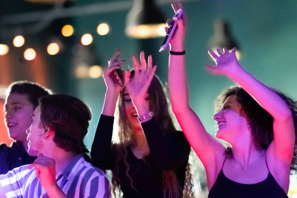 istock Young people having fun in at a concerts 1207066339