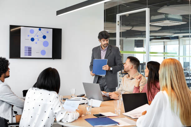 istock Colleagues discussing in board room 1207067599