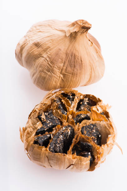 istock Black garlic cloves isolated on white background 1207068010