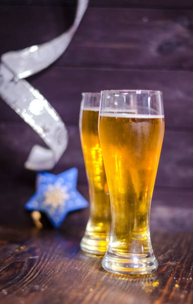 istock beer in glasses on christmas background 1207069252