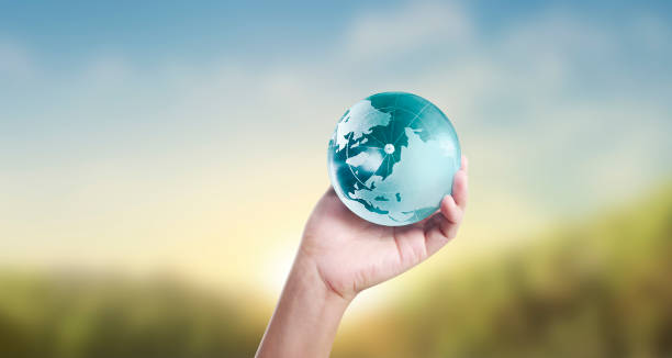 istock Globe ,earth in human hand, holding our planet glowing 1207069411