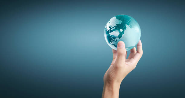 istock Globe ,earth in human hand, holding our planet glowing 1207069412
