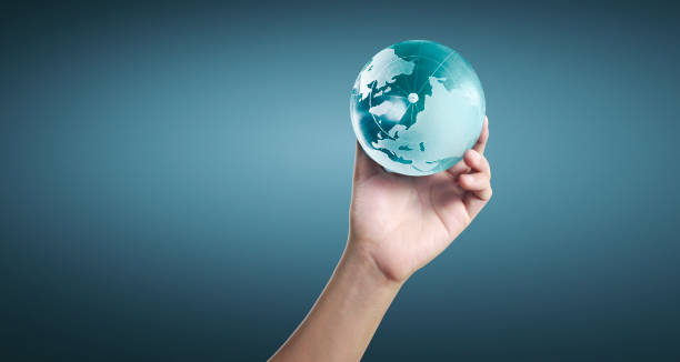 istock Globe ,earth in human hand, holding our planet glowing 1207069413