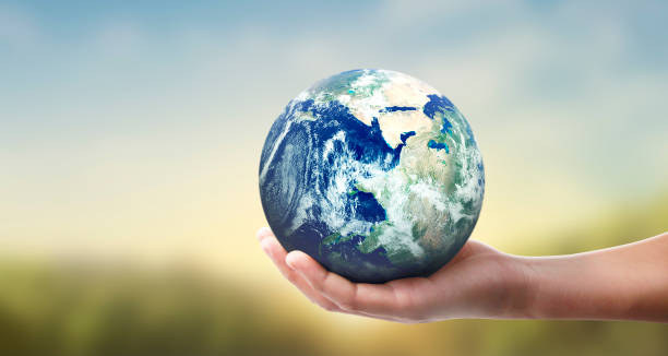istock Globe ,earth in human hand, holding our planet glowing 1207069414
