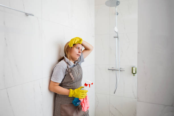 istock Tired woman cleaning shower stall 1207070790