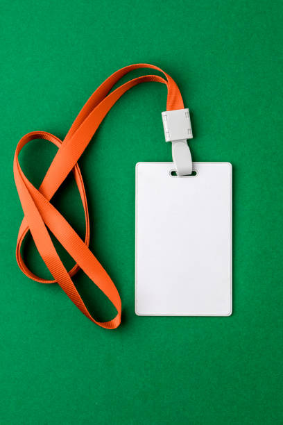 istock Blank security tag with a red stripe neck on a green background. Place for text, layout 1207070804