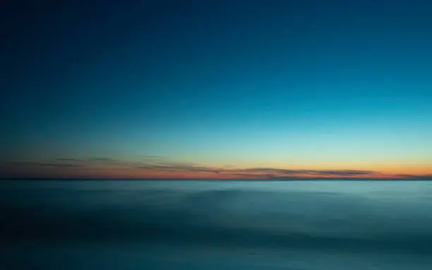 Photo of Tranquil Seascape over the Soft Misty Waves at Twilight