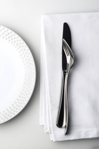 istock Knife and fork on white linnen napkin. 1207072255