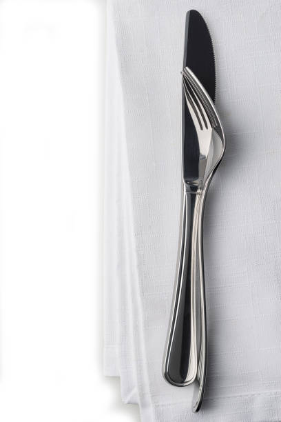 istock Knife and fork on white linnen napkin. 1207072441