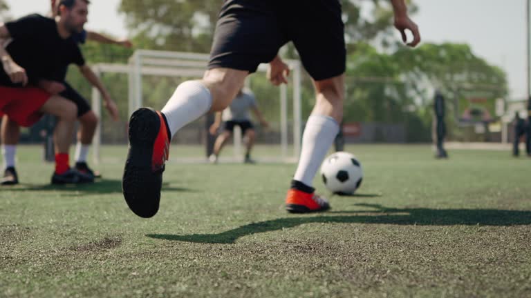 Group of men, soccer team on the field outdoors, training together.